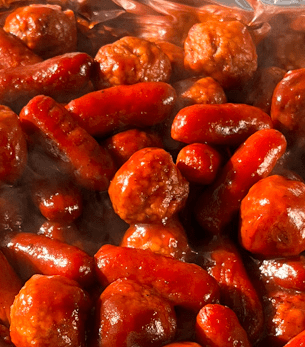 Grilled garlic sausage links served by AHEAD Catering at a Louisiana BBQ event in Bossier City.