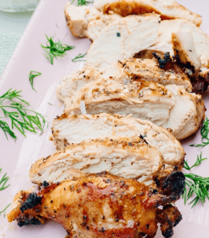 Grilled chicken quarters with golden, crispy skin by AHEAD Catering in Shreveport, Louisiana.